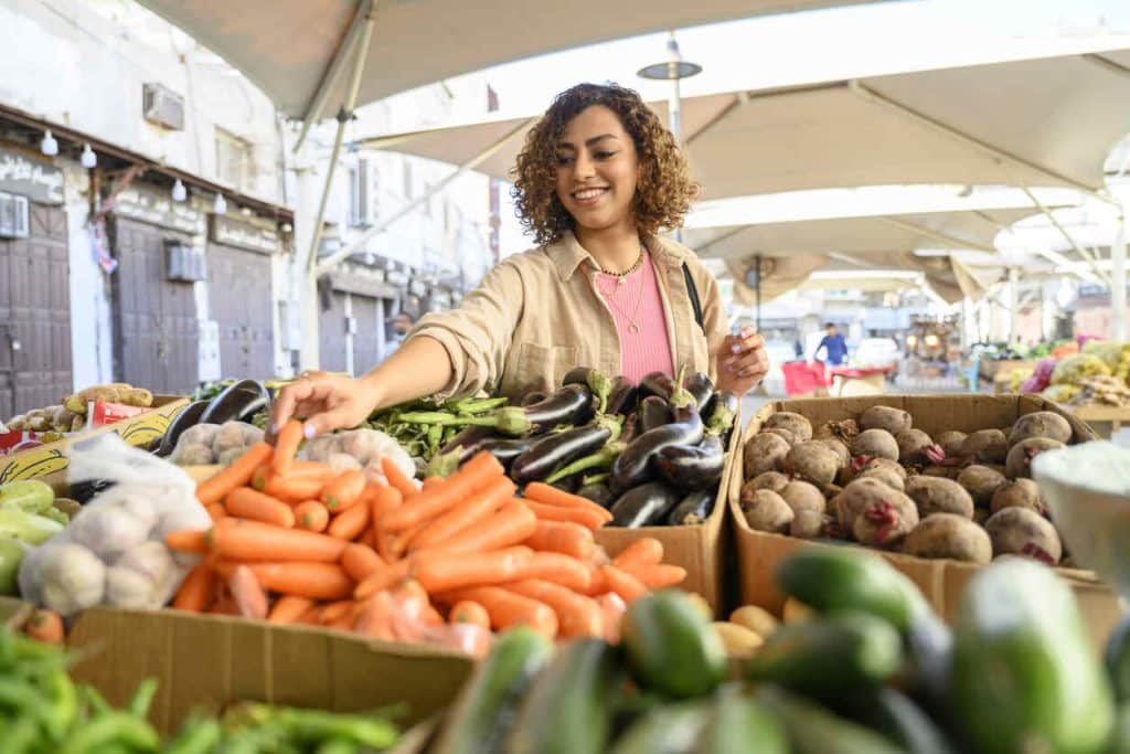 mulher negra jovem fazendo compras na feira